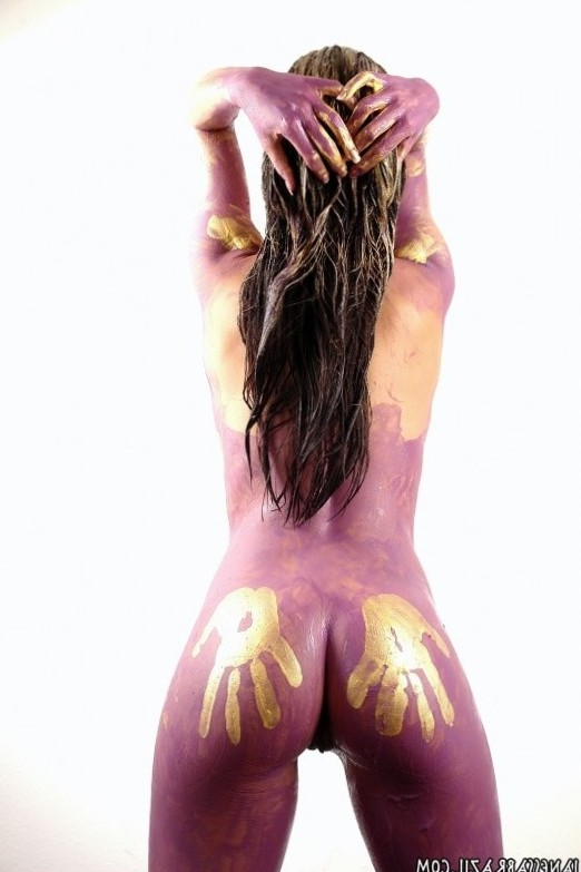 dark-haired woman with violet and golden body paint